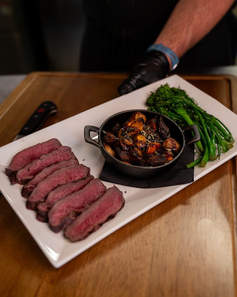 Sliced wood-fired steak with broccolini