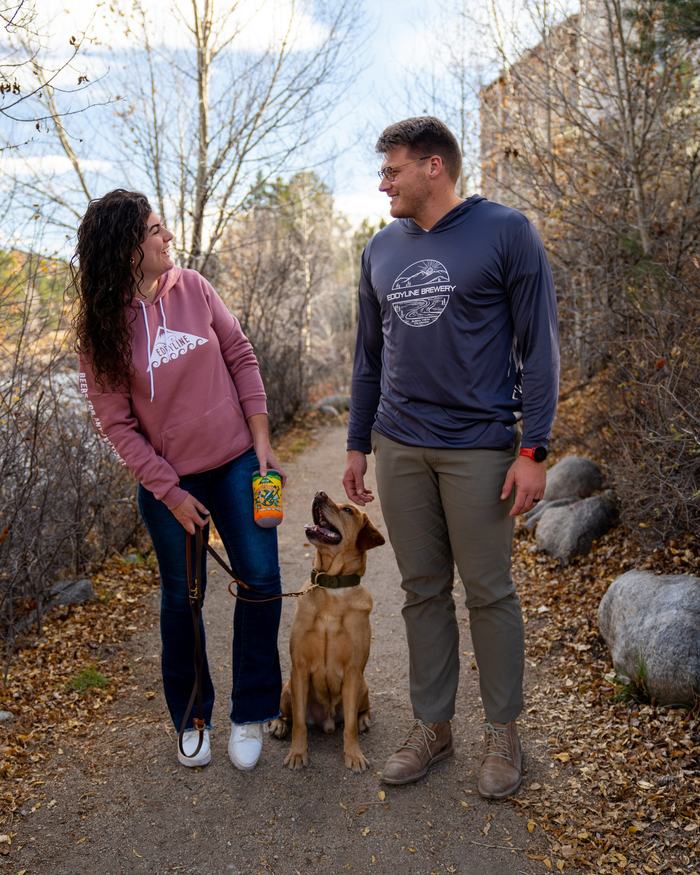 A couple walking their dog along the Arkansas River